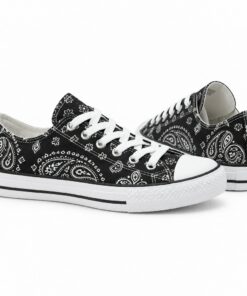 Pair of women's black paisley low-top canvas sneakers standing, side profile and back heel view