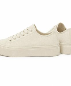 Pair of women's cream low-top platform canvas sneakers standing, side profile and back heel view