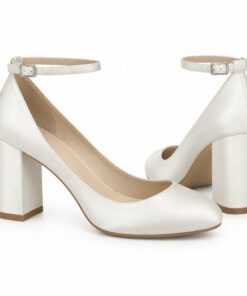 Pair of women's ivory satin bridal pumps with ankle strap and 2.5 inch block heel standing, side profile and back heel view