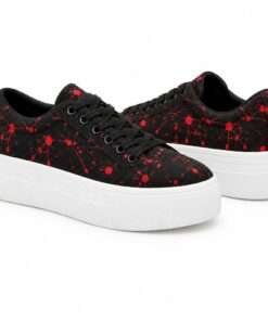 Pair of women's black and red paint splatter low-top platform sneakers standing, side profile and back heel view