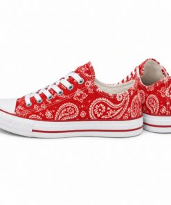 Pair of women's red paisley low-top canvas sneakers standing, side profile and back heel view